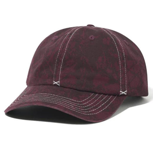 Maroon baseball cap with white stitching on a white background