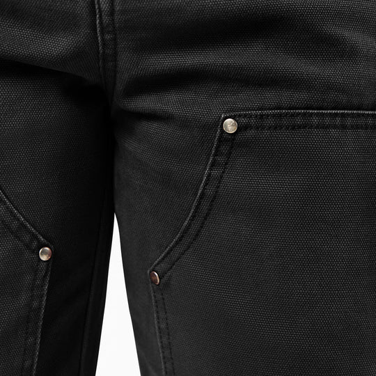 Close-up of double knee black pants with buttons