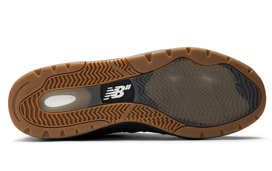 Brown shoe sole with New Balance logo on a white background