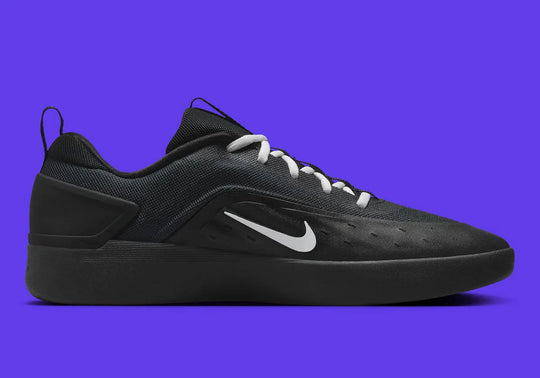 Black sneaker with a white logo on a purple background