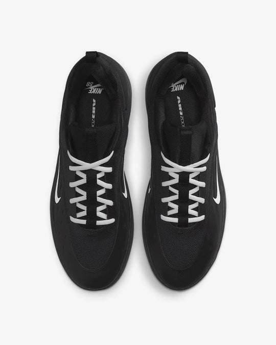 Black Nike sneakers with white laces on a white background