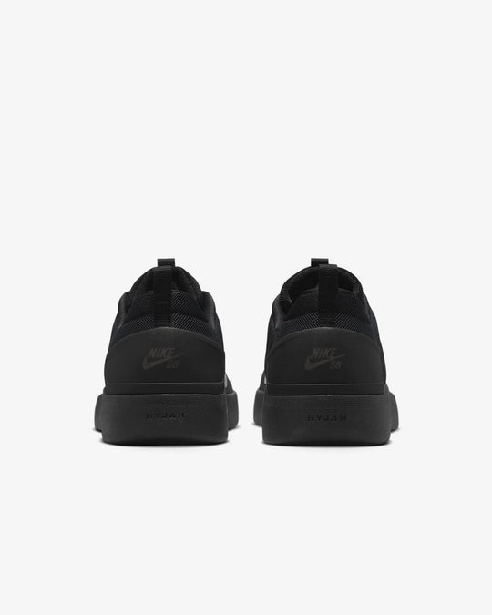 Black Nike sneakers shown from the back on a white background