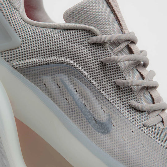 Gray sneaker with a visible brand logo on a light gray background