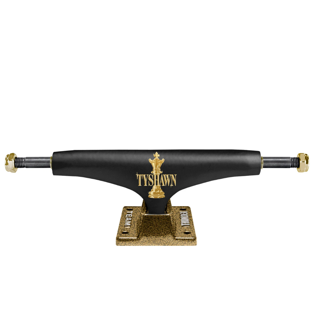 Black and gold skateboard truck with 'Tyshawn' branding on a white background