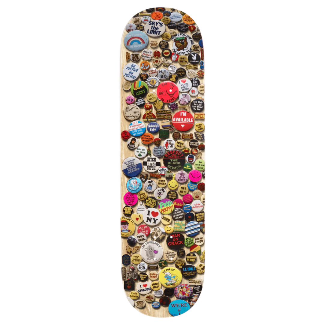 Skateboard deck covered in various colorful stickers on a white background