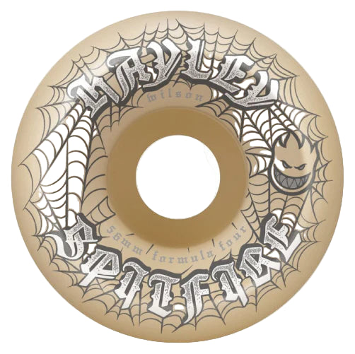 Skateboard wheel with spider web design and 'All Hallows Eve' text on a beige background
