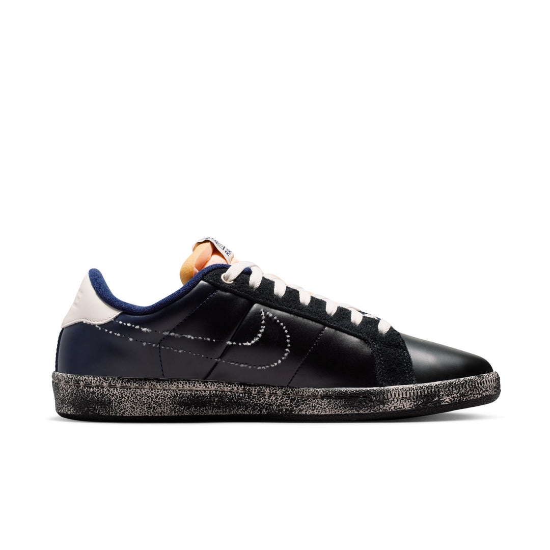 Black sneaker with white and blue accents on a white background
