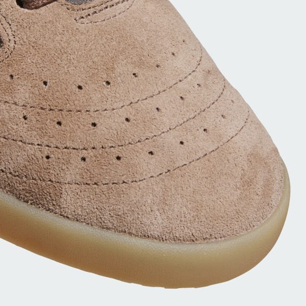 Close-up of a brown suede shoe with a white background