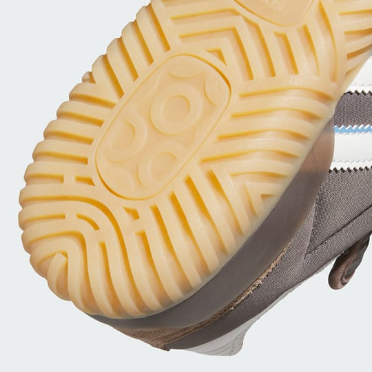 Close-up of a shoe sole with a textured pattern on a light gray background