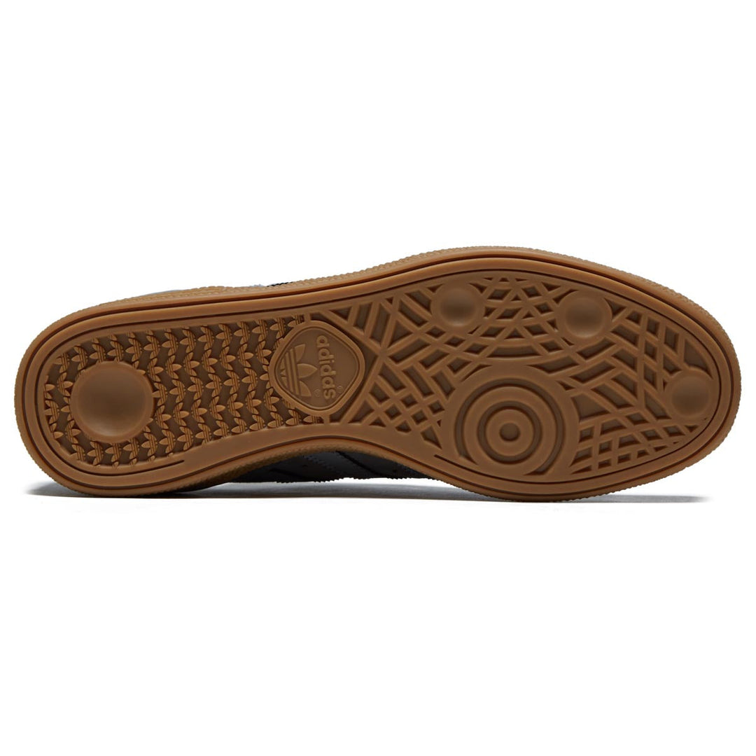 Brown sole of a shoe with a brand logo on a white background