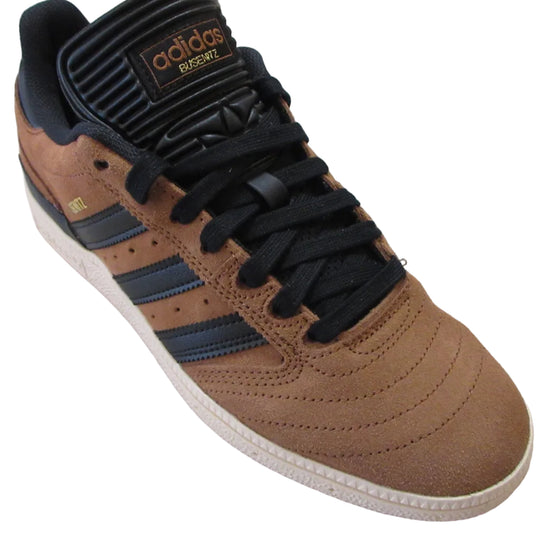 Brown Adidas sneaker with black laces on a white background