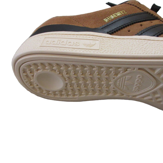 Close-up of an Adidas sneaker sole on a gray surface
