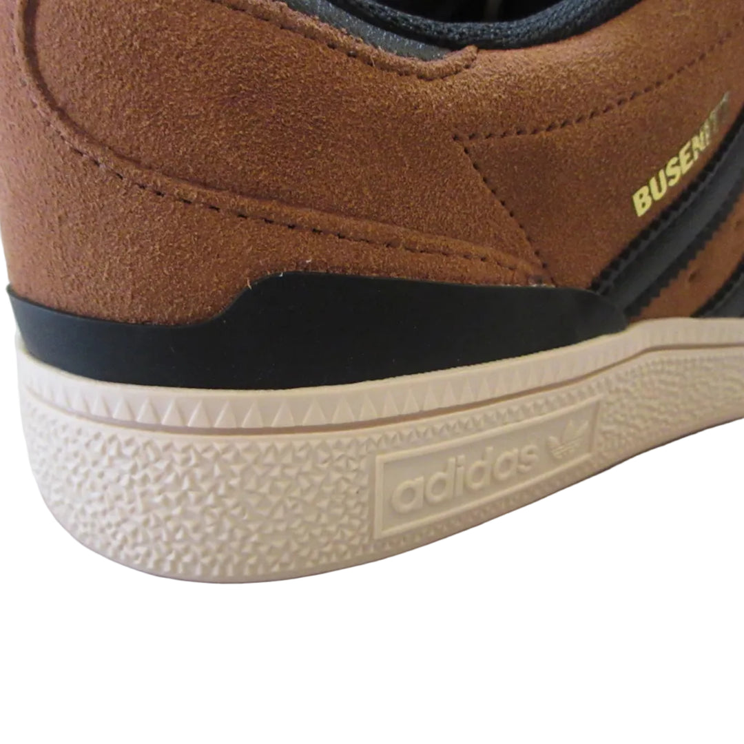 Brown Adidas shoe with visible branding on a light surface