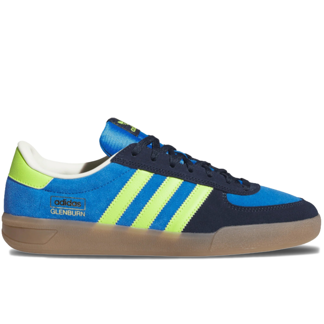 Blue and navy Adidas sneaker with green stripes on a gum sole