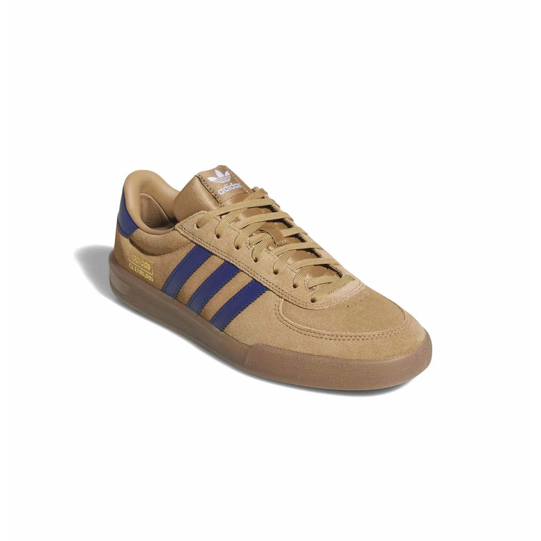 A single Adidas Originals Gazelle sneaker in a tan and brown colorway with blue three-stripes and a gold heel accent, shown on a white background with a soft shadow.