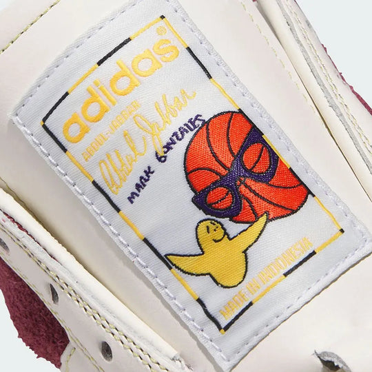 Close-up of an Adidas shoe label with a Gonz cartoon character and basketball design.