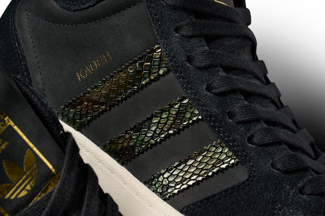 Black sneaker with gold accents and 'Kader' branding on a white background