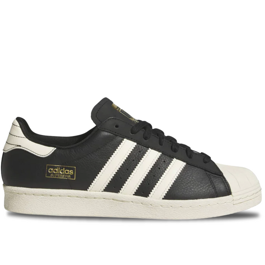 Black Adidas sneaker with white stripes on a white background