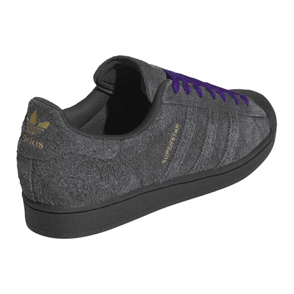 Gray Adidas sneaker with purple laces on a white background
