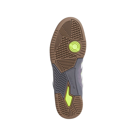multi tread Sole of a shoe with a textured pattern and a green circular logo 