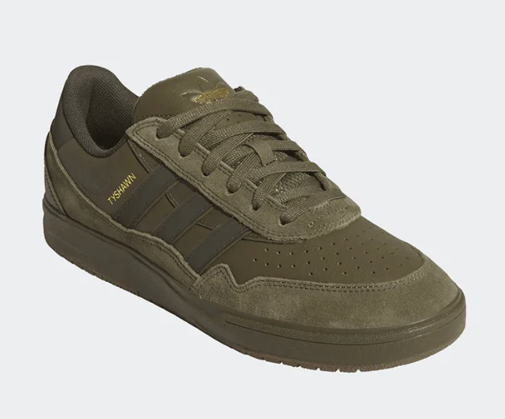 Green sneaker with Adidas logo on a white background
