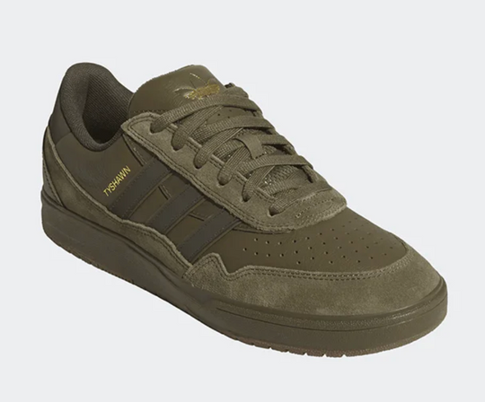 Green sneaker with Adidas logo on a white background