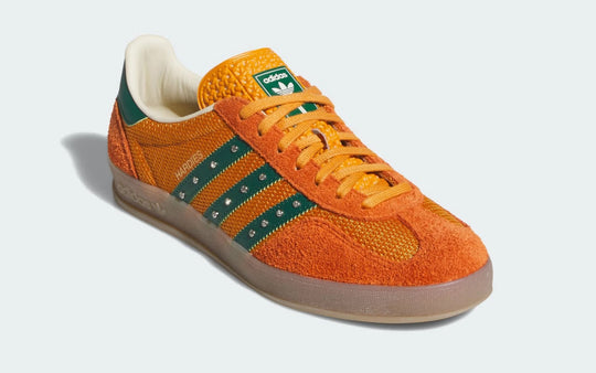 Orange Adidas sneaker with green stripes 