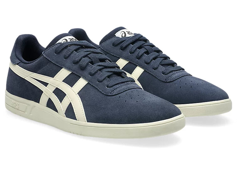 Pair of navy blue sneakers with white accents on a white background
