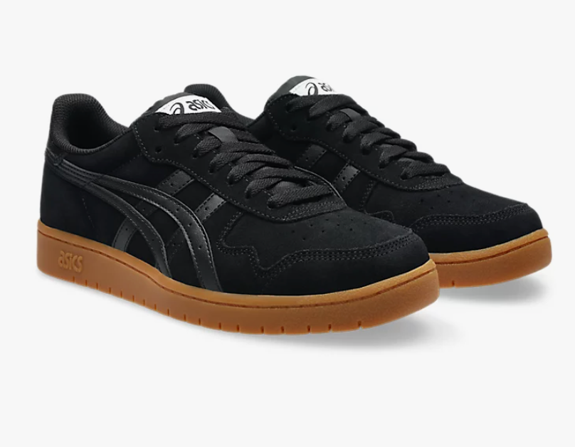 Black sneakers with brown soles on a white background