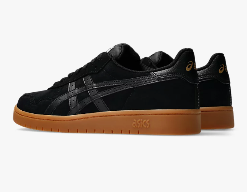 Black sneakers with brown soles on a white background