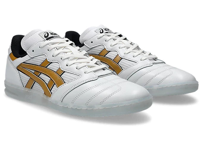 White sneakers with gold accents on a white background