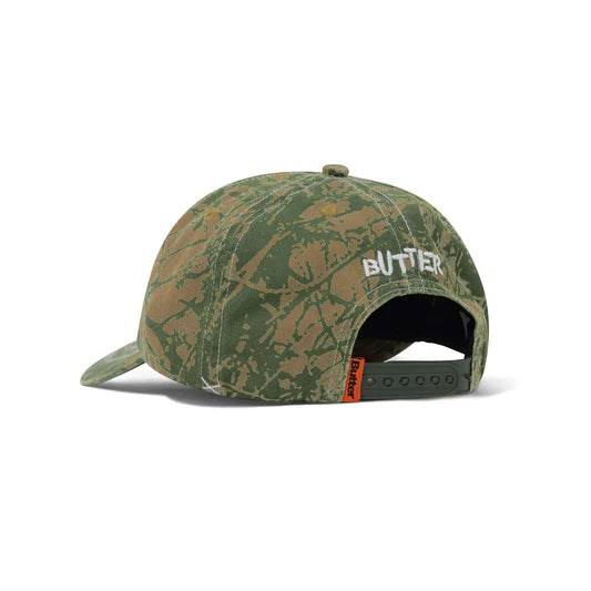 Camouflage-patterned cap with 'Butter' branding on a white background