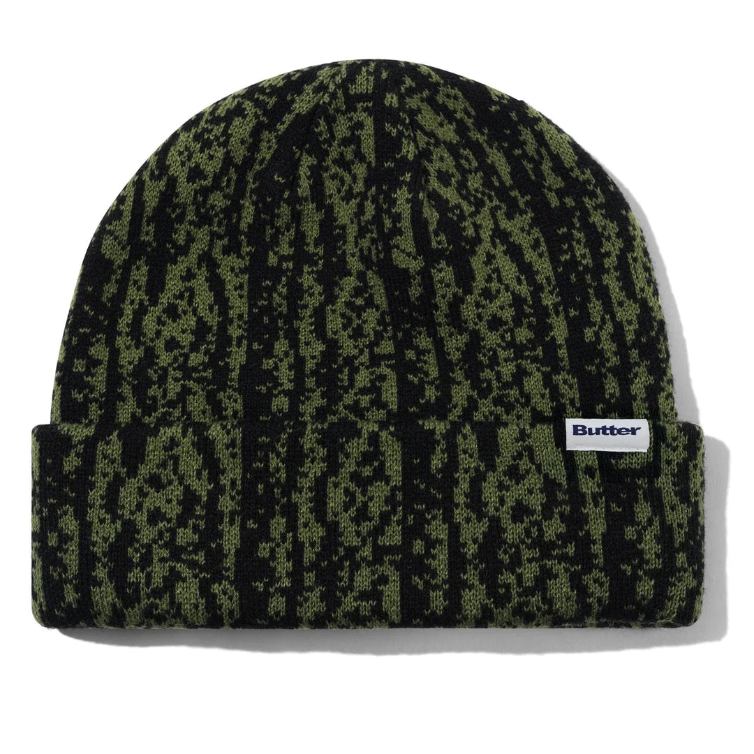 Green and black snakeskin patterned beanie with a brand label 