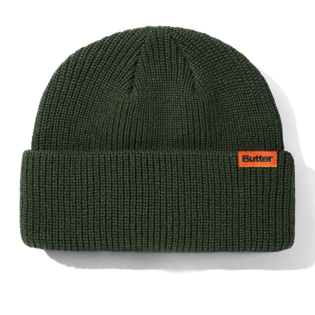 Green beanie with orange logo on a white background
