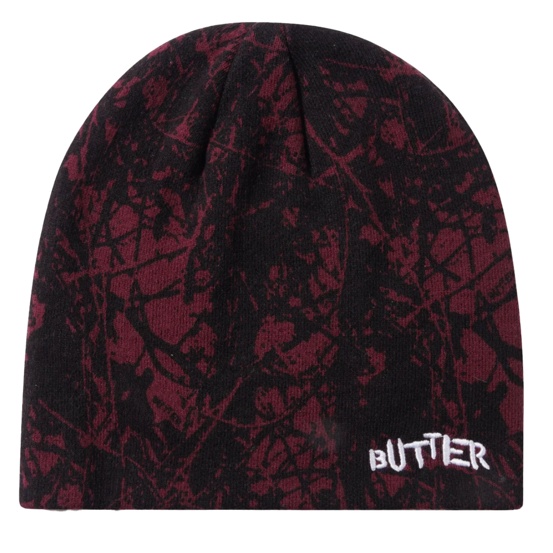 Black and red patterned beanie with 'BUTTER' logo on a white background