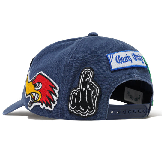 Blue Cash Only cap with various patches including a bird logo, middle finger gesture, and text 