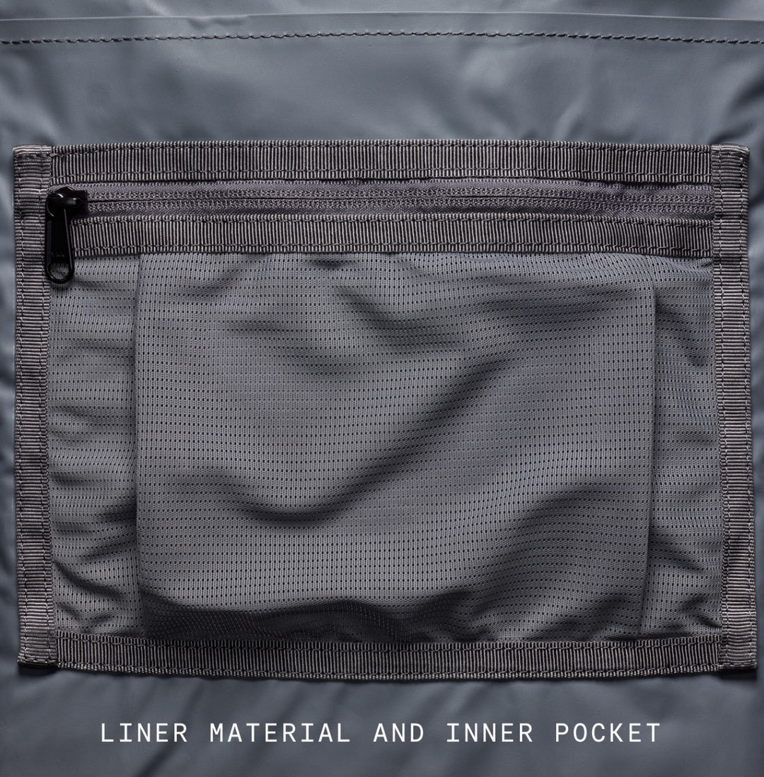 Close-up of a gray liner material and inner pocket on a jacket.