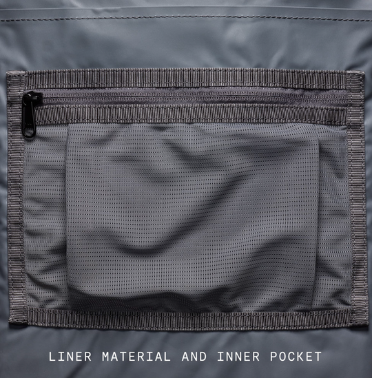 Close-up of a gray liner material and inner pocket on a jacket.