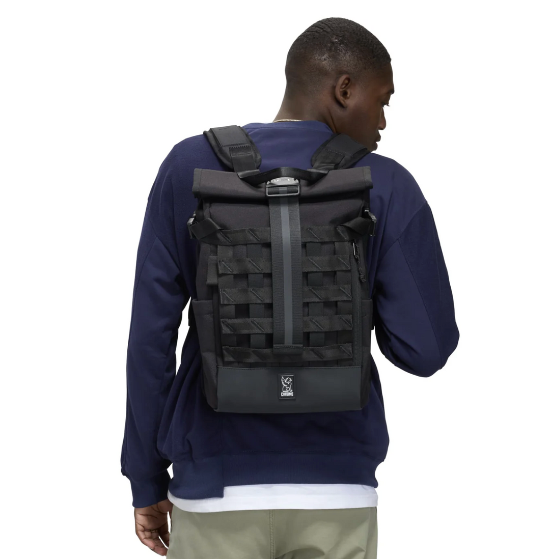 Person wearing a black backpack on a white background