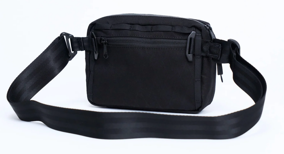 Black waist bag with a strap on a white background