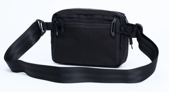 Black waist bag with a strap on a white background