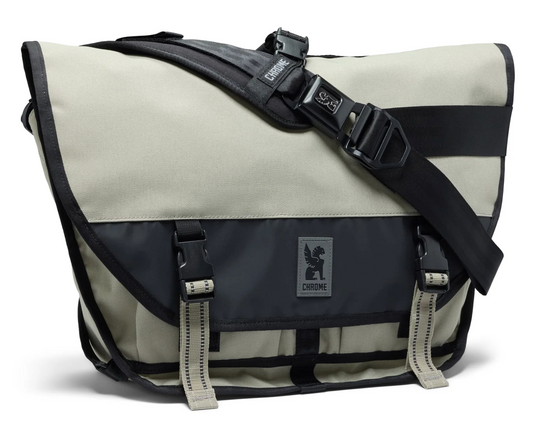 White and black messenger bag with visible brand logo on a white background sage