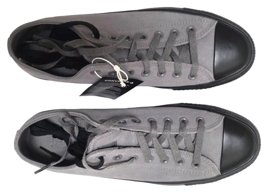 Gray sneakers with black soles on a white background