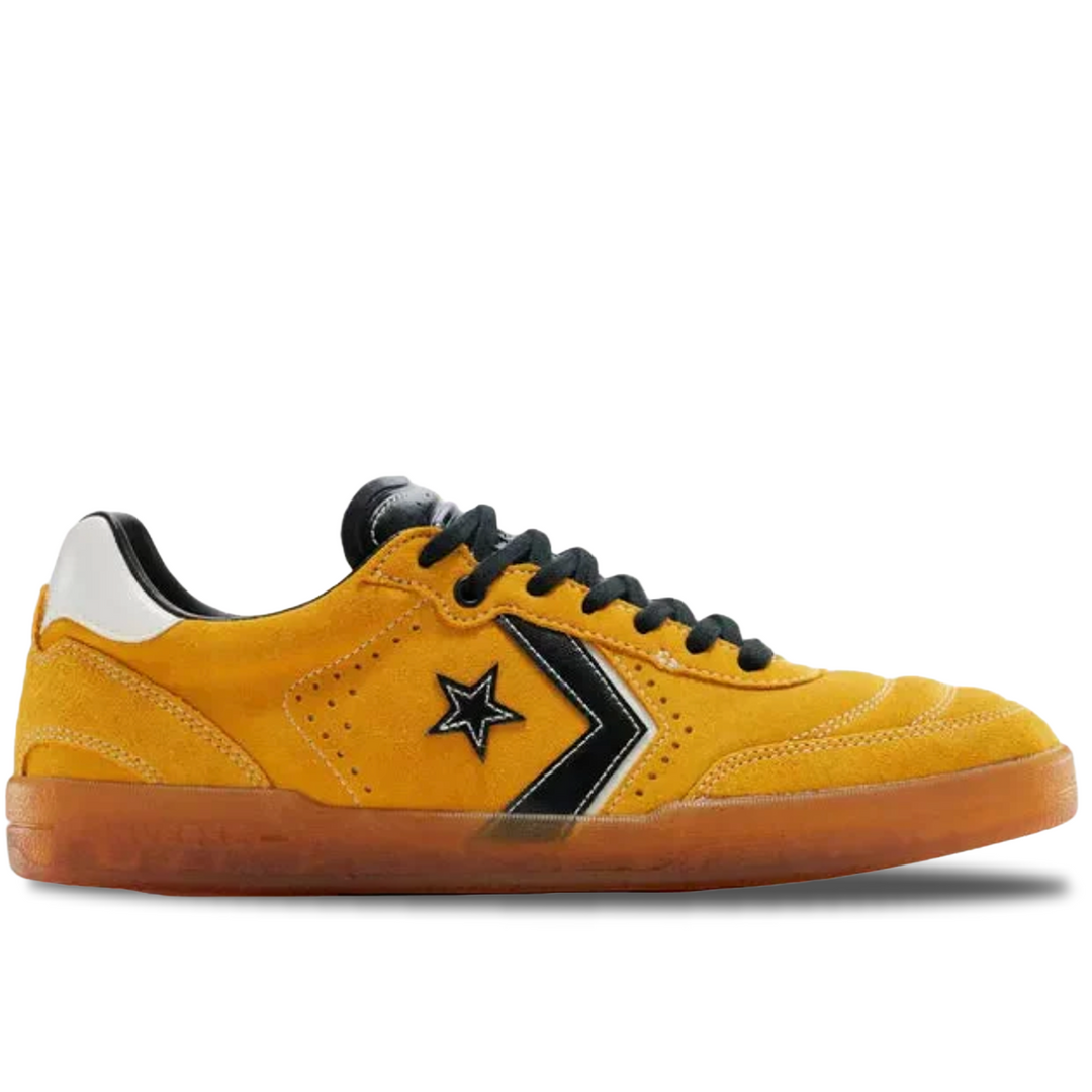 Yellow sneaker with black star logo on a white background