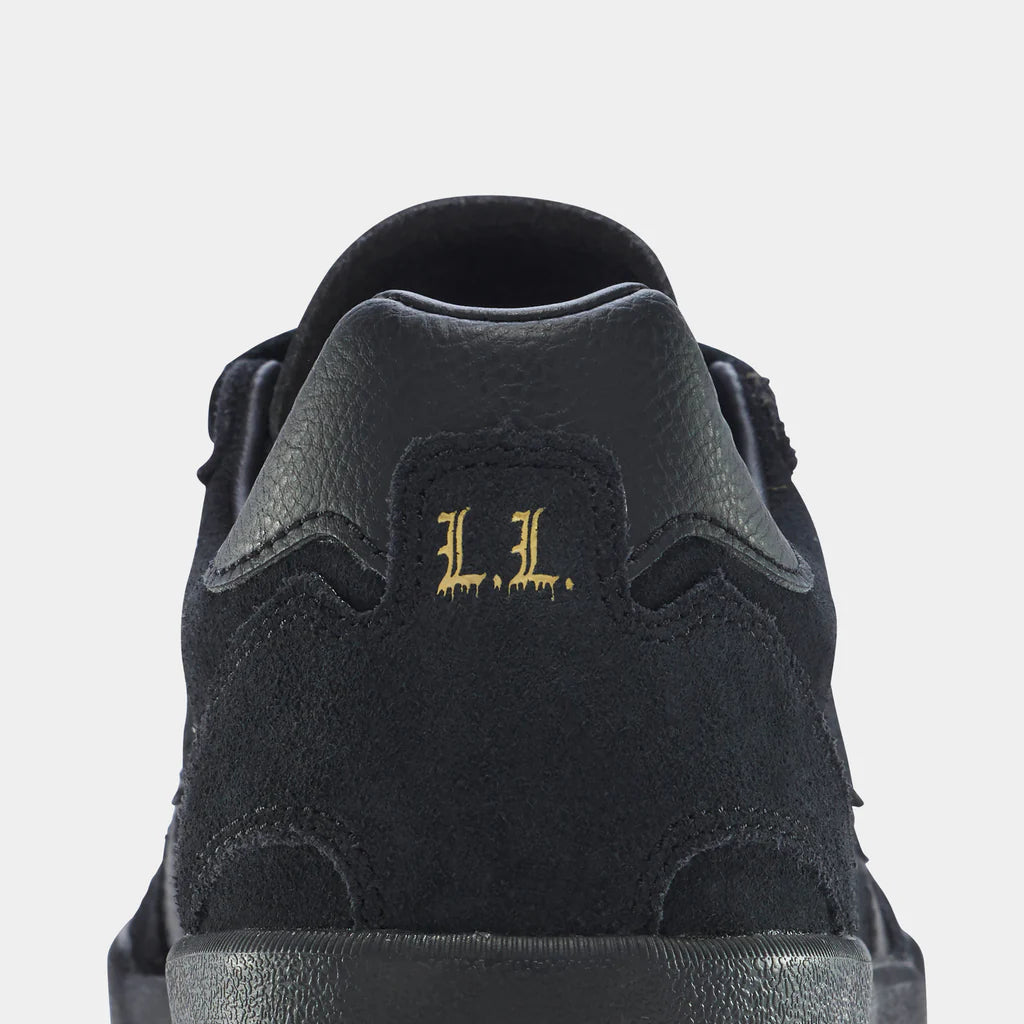 Black sneaker with 'L.L.' logo on a light gray background