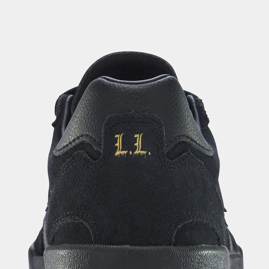 Black sneaker with 'L.L.' logo on a light gray background