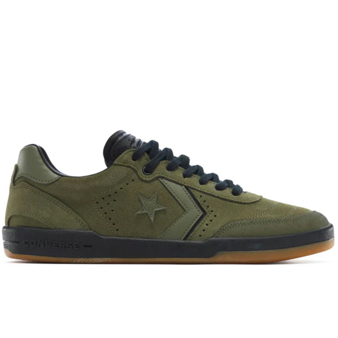Green sneaker with black accents on a white background
