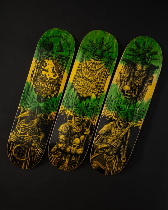 Three skateboard decks with green and yellow designs on a black background