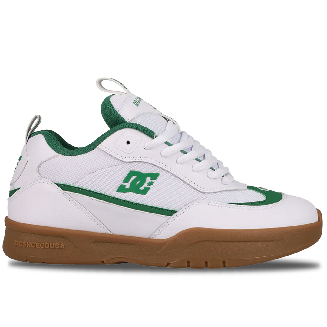 White and green sneaker with brown sole on a white background