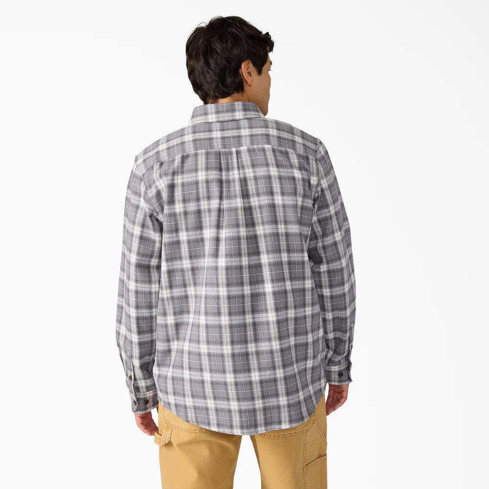 Person wearing a gray plaid shirt back view
